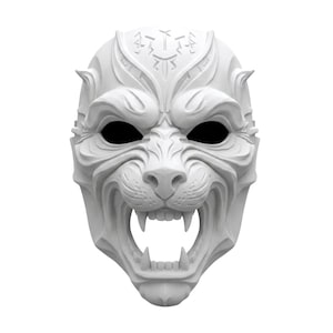 May include: A white, sculpted mask featuring the stylized, snarling face of a predatory feline. The design includes intricate, symmetrical carvings on the forehead, deep-set black eye sockets, and an open mouth revealing sharp, pointed fangs.