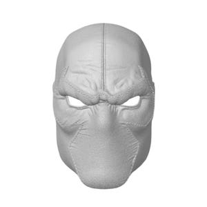 May include: A light gray full-face mask featuring a textured surface that mimics leather. The mask has a vertical center seam, stitched eye openings, and molded contours around the brow and nose area, creating a structured and detailed appearance.
