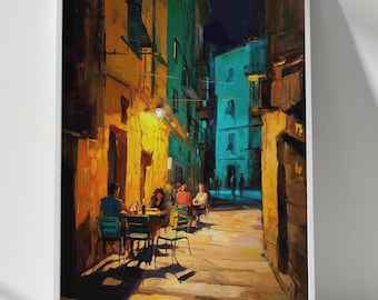 May include: A framed vertical wall art print depicting a narrow European street scene at night. The painting features warm yellow light illuminating outdoor cafe tables and chairs, contrasted by deep blue and green shadows on the stone buildings.