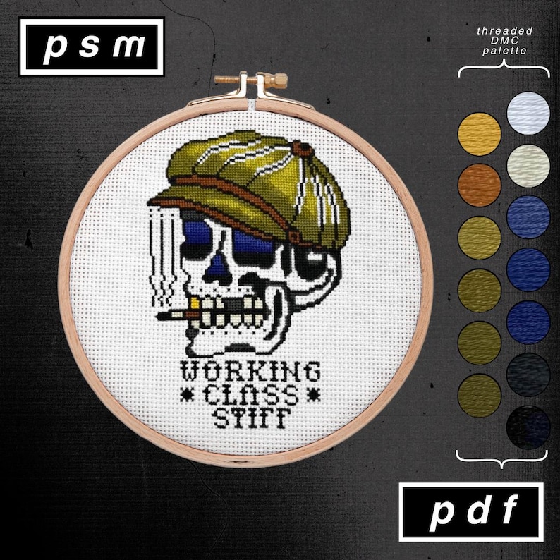 May include: Cross-stitch embroidery in a wooden hoop. The design features a skull wearing a green cap and smoking a cigarette. Text reads "WORKING CLASS STIFF". A color palette is shown on the right, and the letters "psm" and "pdf" are in the corners.