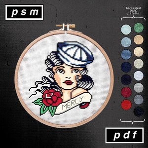 May include: Cross-stitch pattern featuring a vintage-style woman with a sailor hat, a red rose, and the word "Mercy" on a banner. The design is set in a wooden embroidery hoop, with a color palette chart on the right. The text "psm" and "pdf" are in the corners.