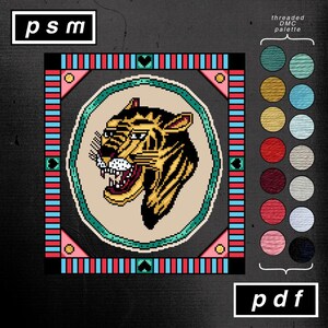 May include: A digital cross-stitch pattern featuring a tiger's head with yellow and black stripes, surrounded by a geometric border in teal, red, and pink. The text "psm" and "pdf" are in the corners, with a color palette on the right.