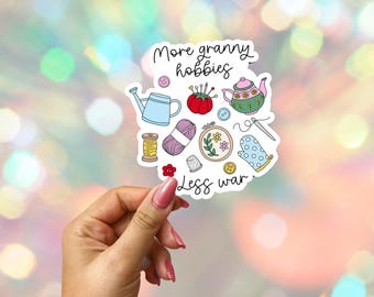 More Granny Hobbies Less War Sticker: Anti-War Political Vinyl Decal, Laptop/Water Bottle
