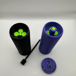May include: Two 3D printed containers with lids, one black and one purple, with a green insert and a black tool. The containers have a logo that says "JP Printworth".