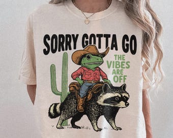 Cowboy Frog Riding Raccoon Graphic Tee, The Vibes Are Off Shirt, Animal Lover Gift