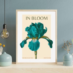 May include: A teal blue iris flower with a yellow center and green stem. The image is titled "In Bloom" and is part of "The Iris Collection" with the variety name "Deep Waters".