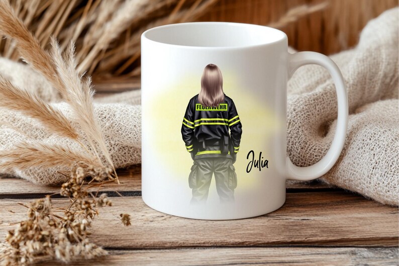 May include: White ceramic mug featuring a firefighter illustration. The design shows a person in a black uniform with yellow stripes and the word "FEUERWEHR". The name "Julia" is written in cursive. The mug is on a wooden surface.