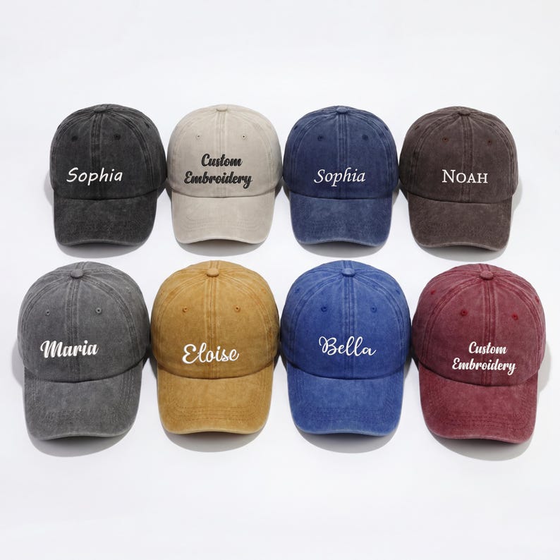 May include: A collection of eight baseball caps in various colors, including black, tan, navy, and brown. Each cap features custom embroidery with names or text like "Sophia," "Maria," and "Custom Embroidery."