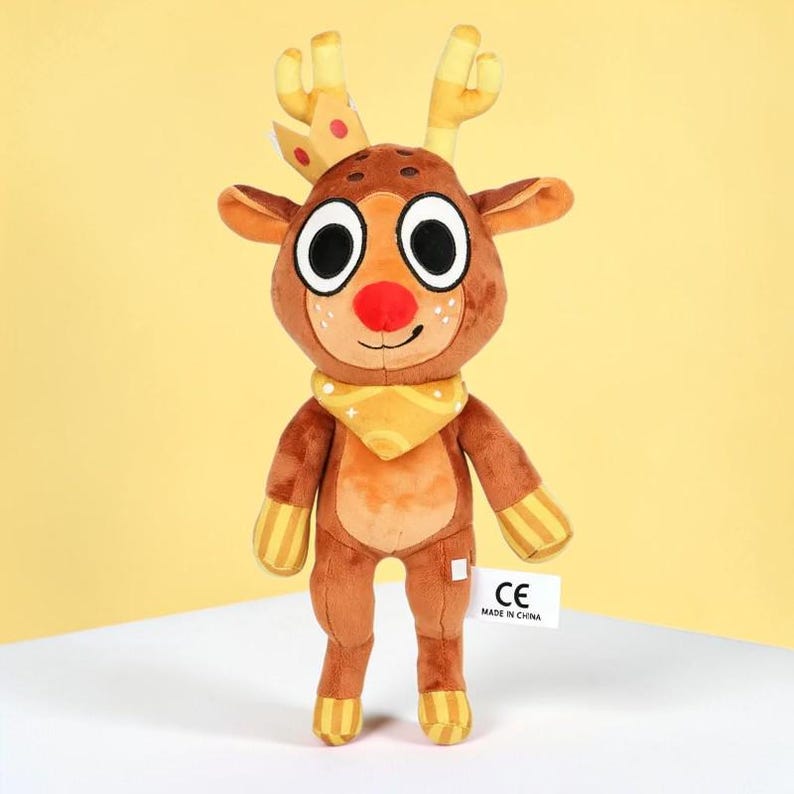 May include: A plush reindeer toy with a brown body, large white-rimmed eyes, and a red nose. It has yellow antlers, a yellow scarf, and yellow striped accents on its legs and arms. A white tag with black text is attached to the toy.