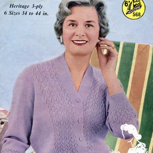 May include: A purple knitted cardigan with a V-neck and button fastening. The cardigan features a delicate openwork pattern and is modelled on a woman wearing a skirt. The image includes the text "Marriner Heritage 3-ply 6 Sizes 34 to 44 in."