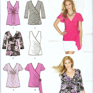 May include: Simplicity sewing pattern 1916 H5 for tops in sizes 6-14. The envelope displays illustrations and photographs of various wrap-style tops with V-necklines, some featuring floral prints, short flutter sleeves, or three-quarter length sleeves.