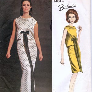 May include: Vogue Paris Original 1404 by Balmain sewing pattern envelope featuring a white sleeveless dress with black polka dots and a long black bow at the waist, alongside a fashion illustration of the same dress in a solid yellow color.