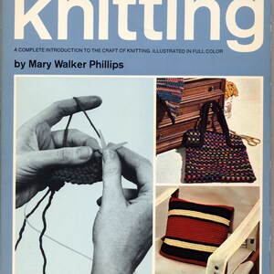 May include: A vintage book cover titled "Knitting" by Mary Walker Phillips. The cover is light blue with the title in large white letters. It features images of knitting projects and hands working with yarn and needles.