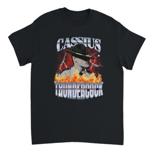May include: Black t-shirt featuring a graphic of a man in a hat with the text "CASSIUS" above and "THUNDERCOCK" below. The graphic has a red and orange flame and lightning design.