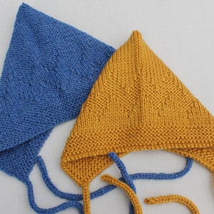 May include: Two knitted baby bonnets, one blue and one yellow, with ties. The bonnets have a diamond pattern.