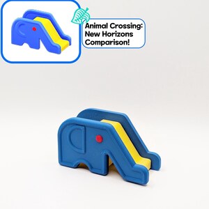May include: A blue and yellow elephant-shaped slide with a red dot on the side. The slide is a toy, and the text "Animal Crossing: New Horizons Comparison!" is in the upper right corner.