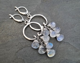 Cascading moonstone dangle earrings, oxidized silver circles with white and blue flash gemstone drops. Long length