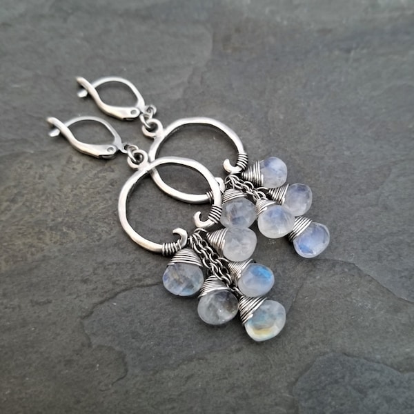 Cascading moonstone dangle earrings, oxidized silver circles with white and blue flash gemstone drops. Long length