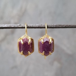 Ruby hexagon drop earrings in a rich gold claw prong setting