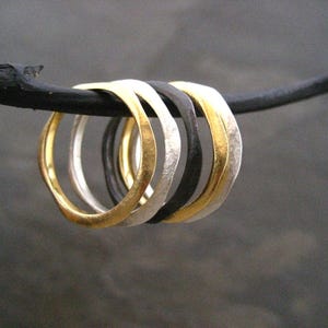 Mixed metal stacking ring set in a wavy textured design finished with gold silver and black oxidizing