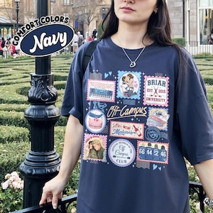 May include: A navy blue t-shirt featuring a collage of colorful graphic stamps and illustrations, including text such as Off-Campus, Briar University, Malone's, and Allie & Dean, with a Comfort Colors Navy label in the upper left corner.