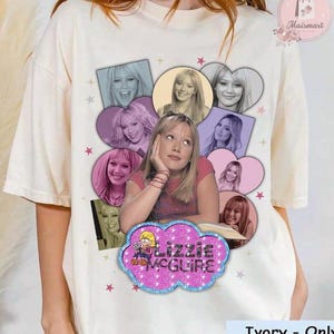 May include: Ivory-colored t-shirt featuring a collage of images of a woman, with a central image of her resting her chin on her hand. The shirt includes a glittery cloud-shaped graphic with the text "Lizzie McGuire".