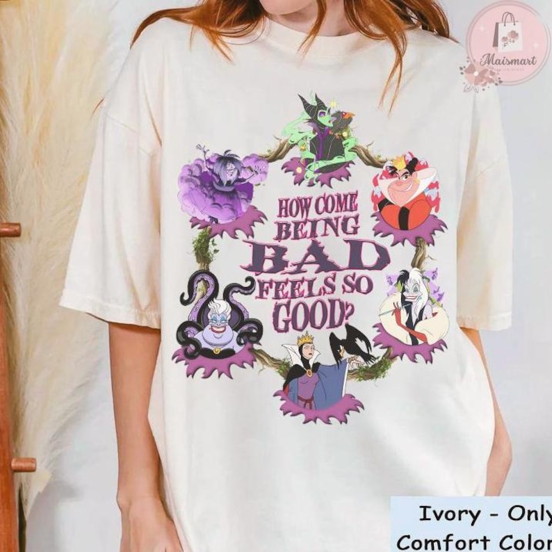 May include: Ivory-colored t-shirt featuring a graphic of Disney villains with the text "HOW COME BEING BAD FEELS SO GOOD?" The design includes Ursula, Maleficent, and the Evil Queen. The shirt is a comfort color.