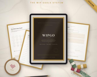 May include: A Wipgo Planner digital set featuring a dark cover with gold accents, multiple white planning pages, a circular embroidery hoop with a heart design, a black pencil, and several small spools of colored thread.