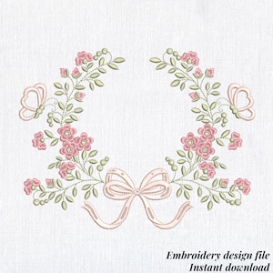 May include: An embroidery design file featuring a floral wreath with pink flowers, green leaves, and two butterflies. A pink bow is at the bottom. The text "Embroidery design file Instant download" is at the bottom.