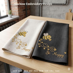 May include: Two decorative kitchen towels, one cream and one charcoal, with machine embroidery. Each towel features a yellow and black bee, gold hearts, stars, and the words "Be Happy". The text "Machine Embroidery Design" is at the top.