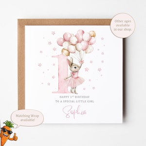 May include: A square greeting card with a brown envelope featuring a watercolour illustration of a rabbit in a pink tutu holding a bunch of pink and white balloons next to a large pink number one. Text reads: HAPPY 1ST BIRTHDAY TO A SPECIAL LITTLE GIRL Sophia.