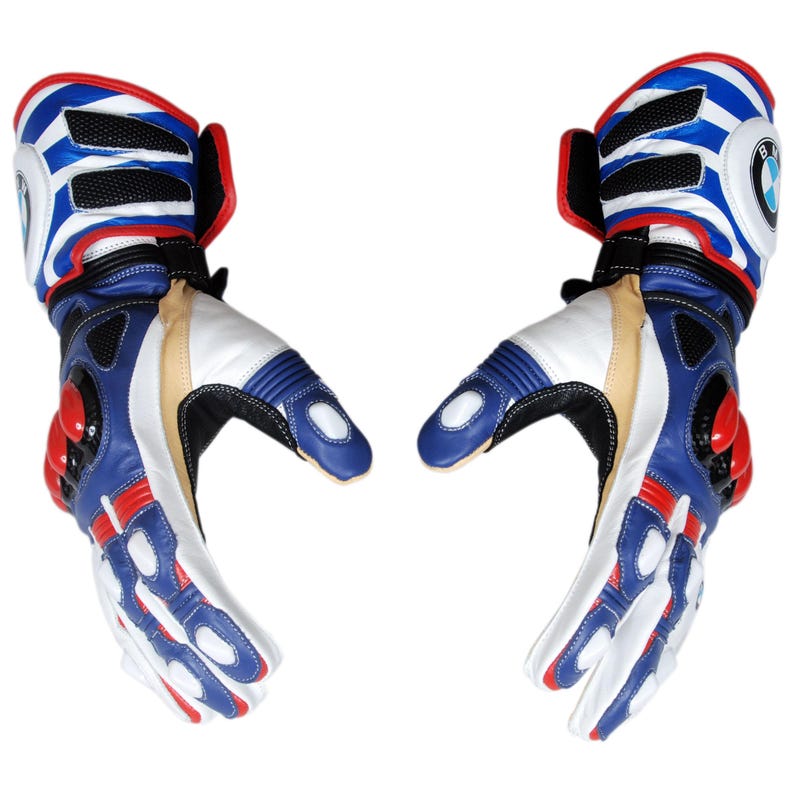May include: Pair of motorcycle gloves in blue, white, red, and black. The gloves feature a BMW logo on the cuff and are made of leather. The design includes padded sections and ventilation. The gloves are designed for protection and performance.
