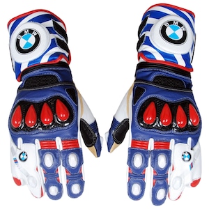 May include: Pair of blue, white, and red motorcycle gloves. The gloves feature the BMW logo on the cuff and the back of the hand. The gloves have red accents on the knuckles and fingers. The gloves are made of leather and other materials.
