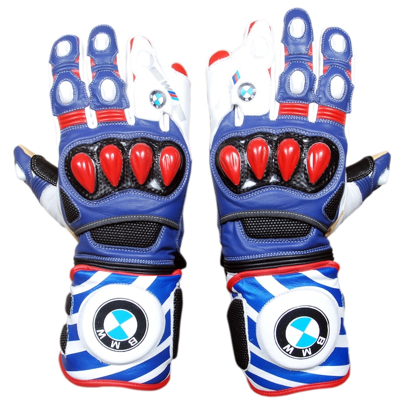 May include: Pair of blue, white, and red motorcycle gloves. The gloves feature a BMW logo on the wrist and finger areas. The gloves have red accents on the knuckles and fingers, with a blue and white striped design on the wrist cuffs.