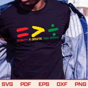 May include: Black t-shirt with the text "EQUALITY IS GREATER THAN DIVISION" in red, yellow, and green. The design includes a red equal sign, a yellow greater than symbol, and a green division symbol.