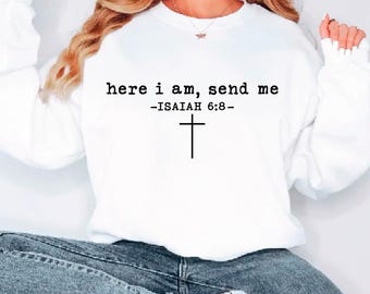 May include: White sweatshirt with the text "here i am, send me -ISAIAH 6:8-" and a black cross. The bottom of the image shows the words "SVG PDF EPS DXF PNG".