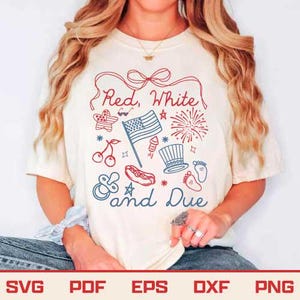 May include: Cream-colored t-shirt with a patriotic design in red and blue. The shirt features the text "Red, White & Due" with illustrations of an American flag, fireworks, and other festive icons. The shirt is a casual style.
