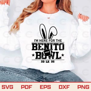May include: White sweatshirt with the text "I'M HERE FOR THE BENITO BOWL" in black. The design includes bunny ears above the text and a football graphic. The sweatshirt also has the text "20 LX 26" below the football graphic.