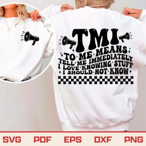May include: White sweatshirt with a black megaphone graphic on the front and back. The back of the sweatshirt features the text "TMI TO ME MEANS TELL ME IMMEDIATELY I LOVE KNOWING STUFF I SHOULD NOT KNOW".