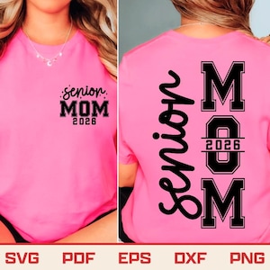 May include: A bright pink t-shirt with the words "Senior MOM 2026" printed in black on the front and back. The back of the shirt also features the word "Senior" vertically.