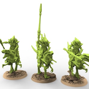 May include: Three green miniature figures of armored riders on dinosaur-like creatures. Each figure is mounted on a different base. The riders hold spears, and the creatures have detailed, textured skin.