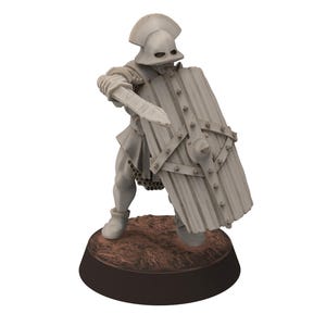 May include: A grey miniature figurine of a medieval knight in armour, holding a sword and shield. The knight is standing on a brown, textured base with a dark brown border. The shield has a series of rivets.