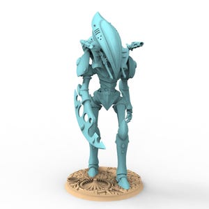 May include: A light blue sci-fi humanoid figurine with a tall, smooth, elongated head, slender limbs, and a large, curved, serrated blade attached to one arm. The figure stands on a circular, textured base with a cracked, desert-like surface.