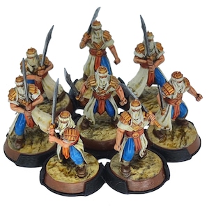 May include: A collection of miniature figurines depicting warriors in traditional garb. The figures are painted with a color palette of white, blue, gold, and brown. Each figure is holding a curved sword and stands on a circular base.