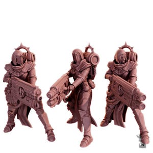 May include: Three miniature figures of armored soldiers, each holding a large weapon. The figures are in a dynamic pose, with detailed armor and helmets. The color is a muted reddish-brown, with a white background.