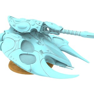 May include: A light blue sci-fi tank miniature featuring a sleek, curved aerodynamic hull, multiple circular vents, and a long, slender forward-pointing cannon barrel. The vehicle is mounted on a circular, textured brown base for display.
