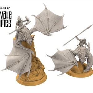May include: Two unpainted miniature figures of a winged creature with a rider, likely for tabletop gaming. The figures are light grey and mounted on a tan base. The text "DESIGNED BY DAVALE GAMES" is visible in the upper left corner.