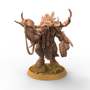 May include: A detailed brown figurine of a fantasy creature, possibly a shaman or warrior, with horns, feathers, and intricate armor. The figure is posed on a small, textured base, with a circular base beneath.