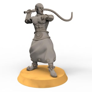 May include: A grey figurine of a bald, muscular figure in a fighting stance, holding a braided weapon. The figure wears a tunic and has a determined expression. It stands on a yellow circular base.