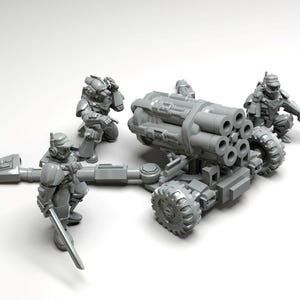 May include: A gray unpainted miniature set featuring a multi-barreled artillery cannon mounted on a wheeled carriage, accompanied by three armored soldier figurines in tactical gear, each holding a weapon, presented as a tabletop gaming model.